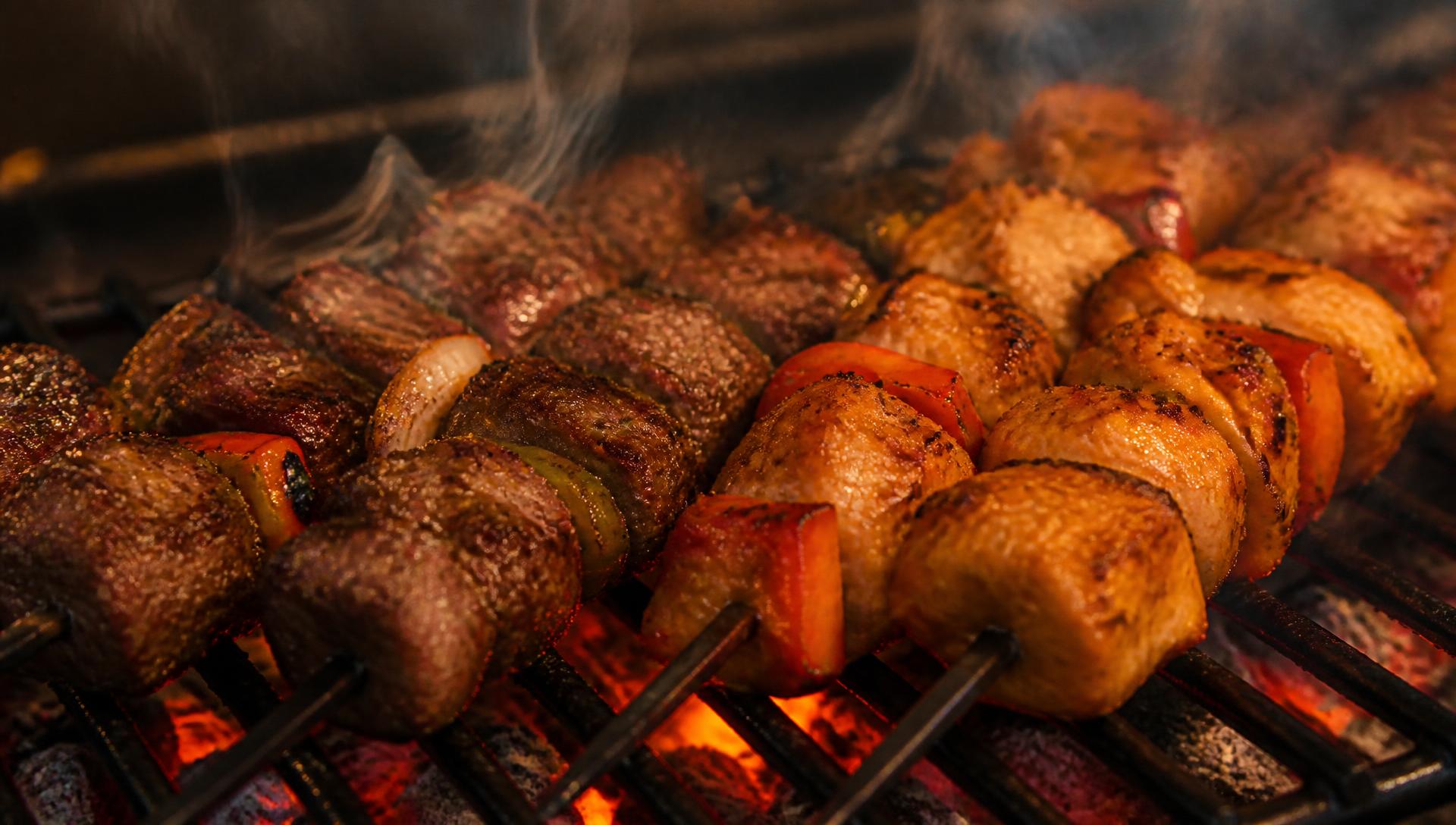 Lamb and chicken shish grilling over charcoal